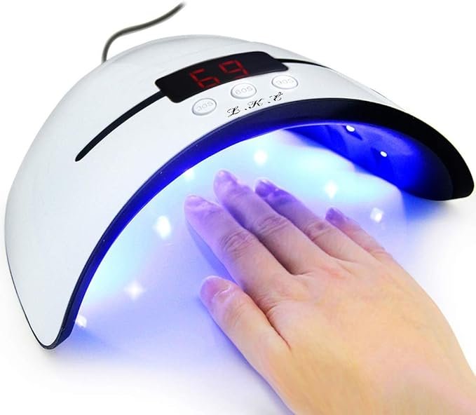 A hand being placed inside a UV LED nail lamp with a digital timer displaying the number 69.